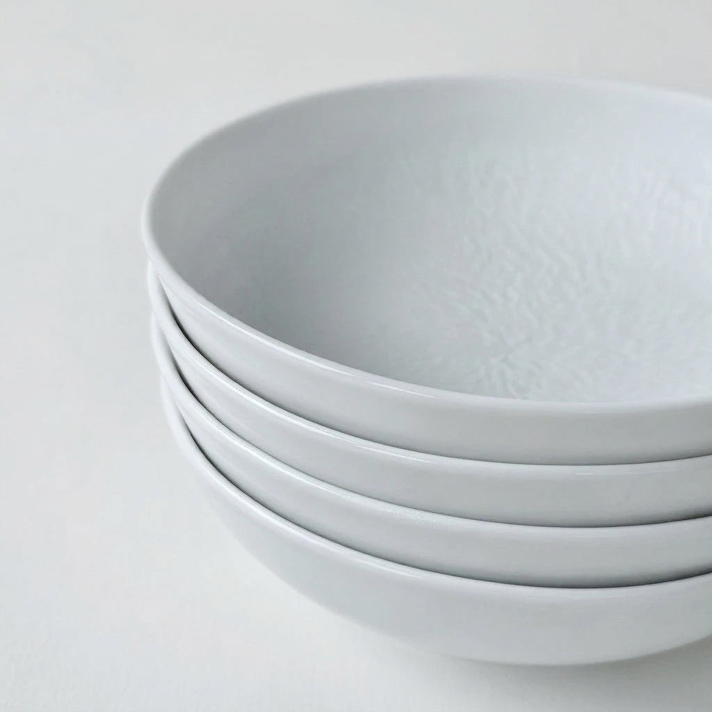Ensemble de quatre assiettes creuses – Minéral – Manufacture Raynaud – Limoges, début du XXIe s.