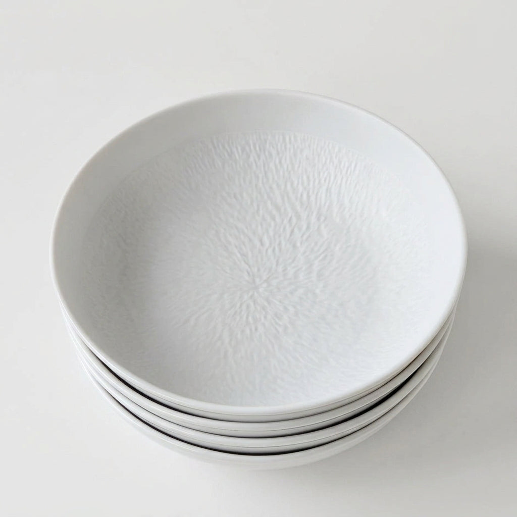 Ensemble de quatre assiettes creuses – Minéral – Manufacture Raynaud – Limoges, début du XXIe s.